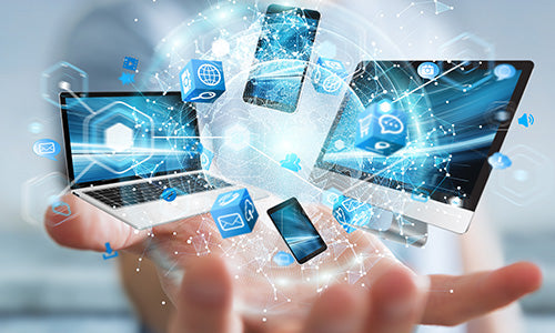 Multiple digital devices displaying connected healthcare and data icons above an open hand