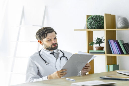 Clinical researcher reviewing paper records during a clinical trial